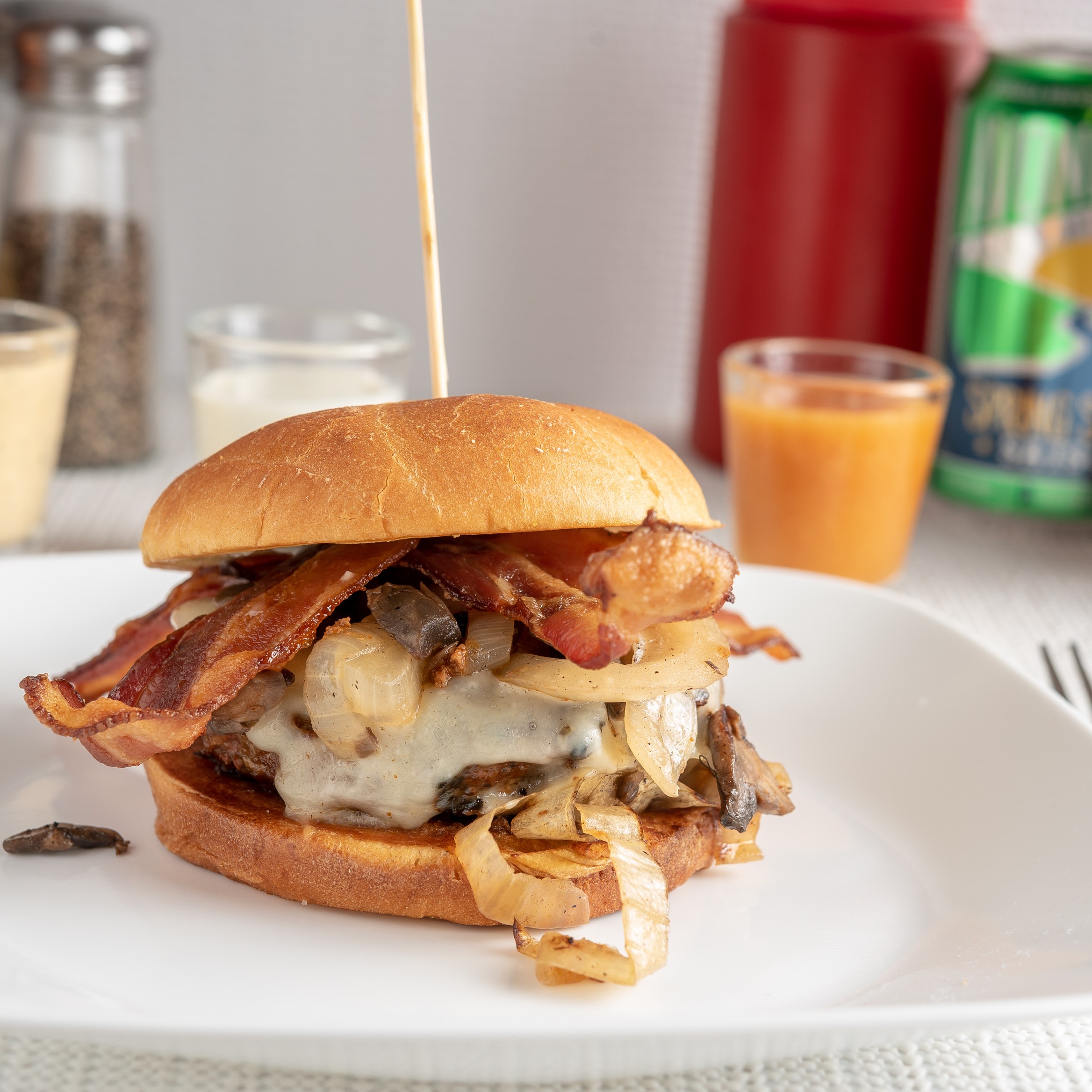 Bacon Swiss burger with melted cheese and bacon on a bun.
